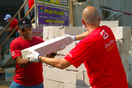 Deutsche Bank volunteers lay bricks for a Happy Hearts special needs school